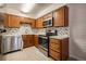 Modern kitchen features stainless steel appliances, sleek countertops, and wooden cabinets at 6800 E Tennessee Ave # 533, Denver, CO 80224
