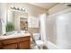 Bathroom features modern white fixtures and a vanity with granite countertop at 1144 Rockhurst Dr # 105, Highlands Ranch, CO 80129