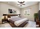 Staged bedroom with modern decor, a decorative headboard, and large comfortable bed at 1144 Rockhurst Dr # 105, Highlands Ranch, CO 80129