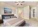 Bedroom with ceiling fan, TV, and access to the kitchen at 1144 Rockhurst Dr # 105, Highlands Ranch, CO 80129
