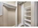Walk in closet with installed shelving to maximize storage at 1144 Rockhurst Dr # 105, Highlands Ranch, CO 80129