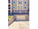 Private garage door for condo unit, with brick facade and lighting, built into a retaining wall at 1144 Rockhurst Dr # 105, Highlands Ranch, CO 80129