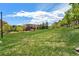 Manicured green space in a neighborhood, with a grassy hill, mature trees, and beautiful condos at 1144 Rockhurst Dr # 105, Highlands Ranch, CO 80129