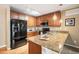 Kitchen with stainless steel appliances, granite countertops, and wood cabinets at 1144 Rockhurst Dr # 105, Highlands Ranch, CO 80129