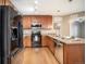 Kitchen with stainless steel appliances, granite countertops, and wood cabinets at 1144 Rockhurst Dr # 105, Highlands Ranch, CO 80129