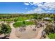Aerial view of neighborhood playground, showcasing play structures, green spaces, and walking paths at 1144 Rockhurst Dr # 105, Highlands Ranch, CO 80129