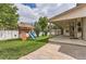 Landscaped backyard with play set and covered patio at 5483 Gunnison Dr, Frederick, CO 80504