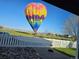 Home's backyard view showcases a colorful hot air balloon over the park and distant mountains, adding unique charm at 5483 Gunnison Dr, Frederick, CO 80504