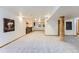 Spacious finished basement featuring a stone bar, neutral carpet, and rustic wooden column at 5483 Gunnison Dr, Frederick, CO 80504