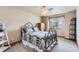 Comfortable bedroom with a decorative iron bed frame, soft carpet, and good natural light offers relaxation at 5483 Gunnison Dr, Frederick, CO 80504