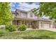 Spacious two-story home with a covered front porch, beautiful landscaping, brick accents, and an attached two-car garage at 5483 Gunnison Dr, Frederick, CO 80504