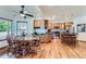 Open kitchen featuring wood cabinets, stainless steel appliances, a kitchen island, and adjacent dining area at 5483 Gunnison Dr, Frederick, CO 80504