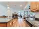 Bright kitchen area with hardwood floors, granite countertops, and an archway leading to the living room at 5483 Gunnison Dr, Frederick, CO 80504