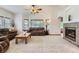 Comfortable living room with plush seating, a ceiling fan, a fireplace, and neutral decor at 5483 Gunnison Dr, Frederick, CO 80504