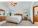 Spacious main bedroom suite features vaulted ceilings, large windows, and an ensuite bathroom with oak trim at 5483 Gunnison Dr, Frederick, CO 80504