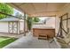 Covered patio featuring a hot tub, shed, and mature landscaping at 5483 Gunnison Dr, Frederick, CO 80504
