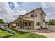 Back of house featuring a long covered patio, play set, and large yard at 5483 Gunnison Dr, Frederick, CO 80504