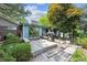 Backyard featuring a wooden deck, built-in seating, mature trees and lush landscaping at 10150 Melody Dr, Northglenn, CO 80260