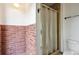 Tiled shower with gold frame at 10150 Melody Dr, Northglenn, CO 80260