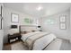 Bright bedroom with a bed, windows, carpet, and neutral paint at 10150 Melody Dr, Northglenn, CO 80260