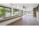 Spacious enclosed patio featuring brick flooring, large windows, and rustic wood accents at 10150 Melody Dr, Northglenn, CO 80260