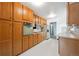 Galley kitchen featuring wood cabinets, laminate countertops, and white appliances at 10150 Melody Dr, Northglenn, CO 80260