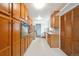 Galley kitchen featuring wood cabinets, appliances, and laminate flooring at 10150 Melody Dr, Northglenn, CO 80260