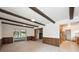 Bright living room with wood paneling, exposed beams and slider to sunroom at 10150 Melody Dr, Northglenn, CO 80260