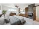 Spacious main bedroom featuring a ceiling fan, carpet, and ensuite bathroom with a double vanity at 10150 Melody Dr, Northglenn, CO 80260