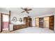 Spacious main bedroom featuring a ceiling fan, carpet, and ensuite bathroom with a double vanity at 10150 Melody Dr, Northglenn, CO 80260