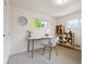 Bright home office with white desk, grey chair, natural light, and stylish decor at 10150 Melody Dr, Northglenn, CO 80260