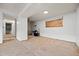 Unfinished basement area featuring concrete floors, white-painted walls, and a covered window for potential customization at 1723 Robb St # 43, Lakewood, CO 80215