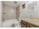 Bathroom featuring a shower-tub combination with tile surround and a vanity sink with mirror, awaiting customization at 1723 Robb St # 43, Lakewood, CO 80215