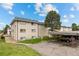 Apartment building with covered parking and mature landscaping at 1723 Robb St # 43, Lakewood, CO 80215