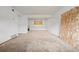 Spacious living room featuring white brick walls, plywood, and natural light at 1723 Robb St # 43, Lakewood, CO 80215