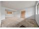 Spacious living room featuring white brick walls, plywood, and natural light at 1723 Robb St # 43, Lakewood, CO 80215