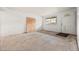 Bright living room featuring white brick walls, plywood, closet, and ample natural light at 1723 Robb St # 43, Lakewood, CO 80215