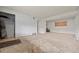 Spacious living room featuring white brick walls, plywood, and natural light at 1723 Robb St # 43, Lakewood, CO 80215