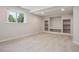 Finished basement with custom shelving, neutral paint, and carpet at 19157 E Progress Ave, Centennial, CO 80015