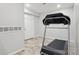 Finished basement area featuring tile floors, neutral paint and a treadmill for a home gym at 19157 E Progress Ave, Centennial, CO 80015