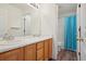 Bathroom with a double sink vanity and a separate shower and toilet space with a curtain at 19157 E Progress Ave, Centennial, CO 80015