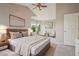 Staged bedroom with a large bed, sitting area, and art at 19157 E Progress Ave, Centennial, CO 80015