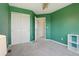 Bedroom boasting ample closet space, green walls, and neutral carpet at 19157 E Progress Ave, Centennial, CO 80015