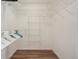 Walk-in closet with custom organizers and wood flooring at 19157 E Progress Ave, Centennial, CO 80015