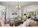 Stylishly staged dining area with hardwood floors, a glass table, and modern décor, creating an inviting space at 19157 E Progress Ave, Centennial, CO 80015