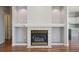 Living room fireplace, hardwood floors, neutral paint and a white painted mantle at 19157 E Progress Ave, Centennial, CO 80015