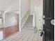 Bright foyer featuring tile flooring, a staircase, and an open view to the living room, creating an inviting entrance at 19157 E Progress Ave, Centennial, CO 80015