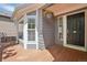 Cozy front porch featuring wood flooring, white trim, and a hanging flower basket, enhancing curb appeal at 19157 E Progress Ave, Centennial, CO 80015