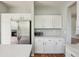 Bright kitchen features white cabinetry, stainless steel refrigerator and spacious countertop at 19157 E Progress Ave, Centennial, CO 80015