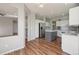 Open-concept kitchen featuring white cabinetry, stainless steel refrigerator and a functional island at 19157 E Progress Ave, Centennial, CO 80015